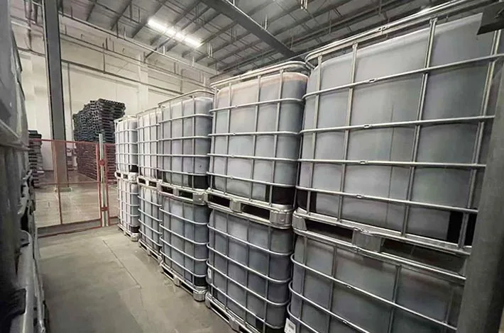 Rows of stacked IBC containers in an indoor storage area
