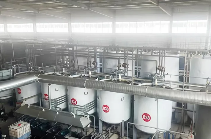 Industrial processing tanks and pipework inside a production workshop